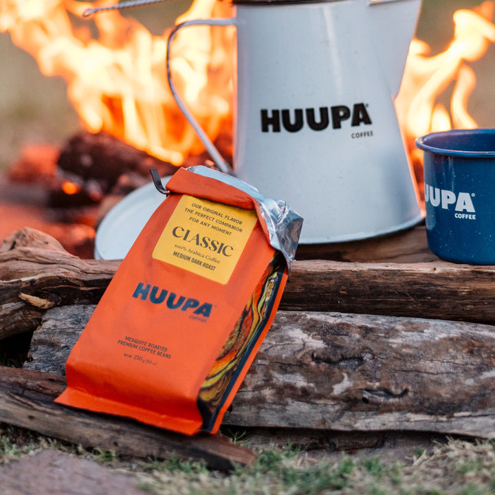 HUUPA coffee package and mug on a campfire background