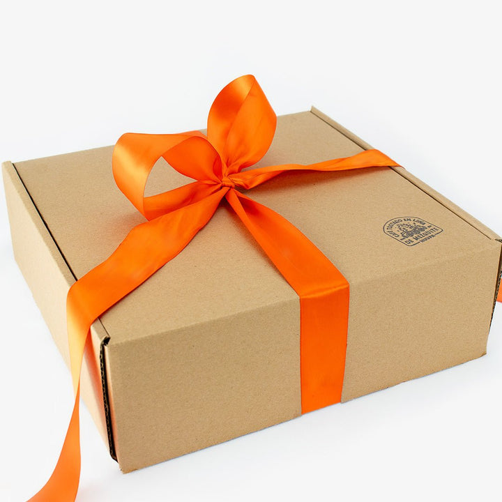 Brown gift box with an orange ribbon on a white background