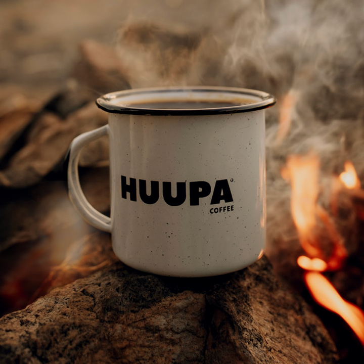 Huupa enamel white mug with a bonfire background