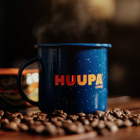 Blue mug with 'HUUPA' branding on coffee beans