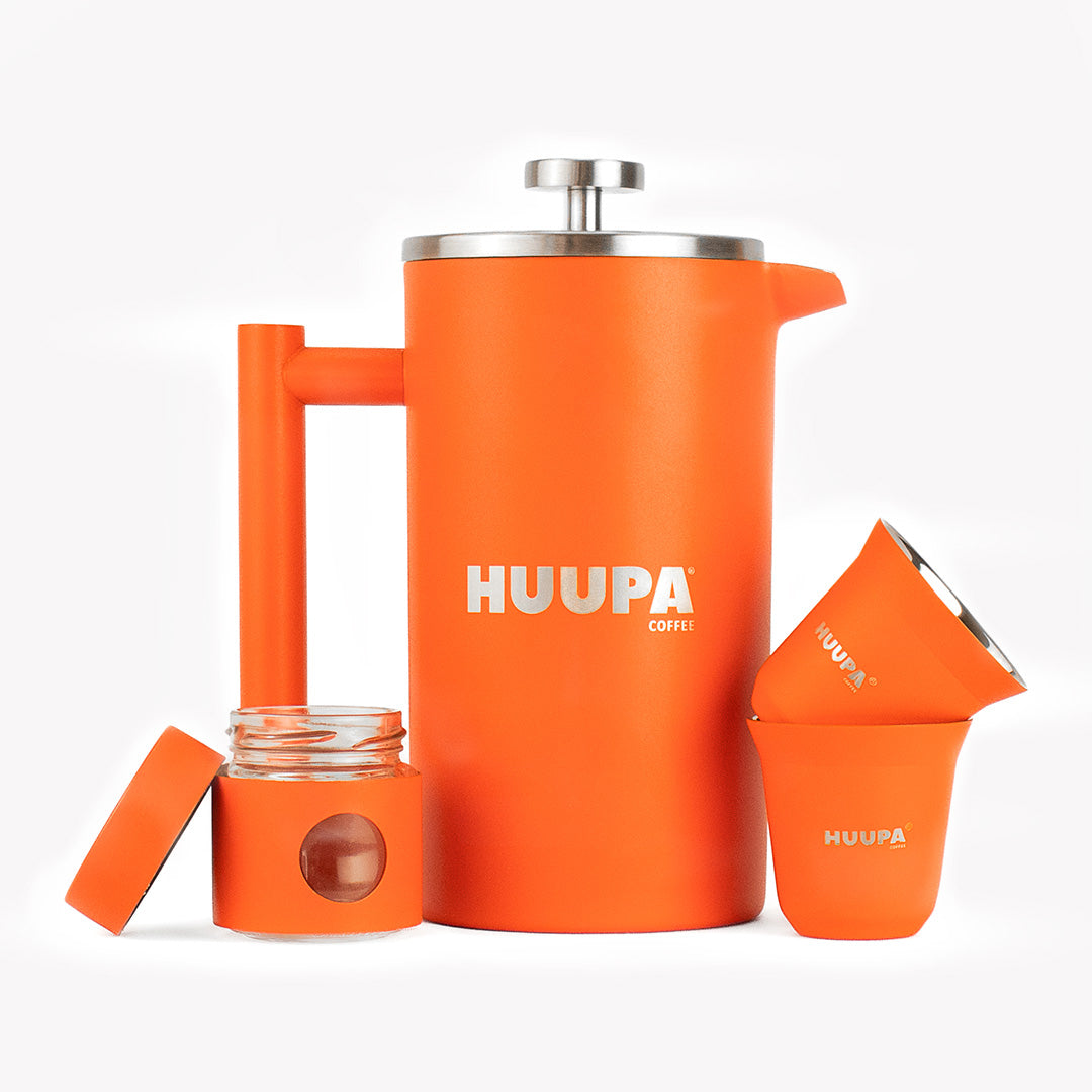Orange coffee press and accessories with &