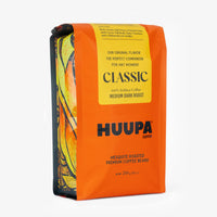 Orange coffee bag with 'HUUPA Coffee' branding on a white background