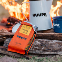 HUUPA coffee package and mug on a campfire background