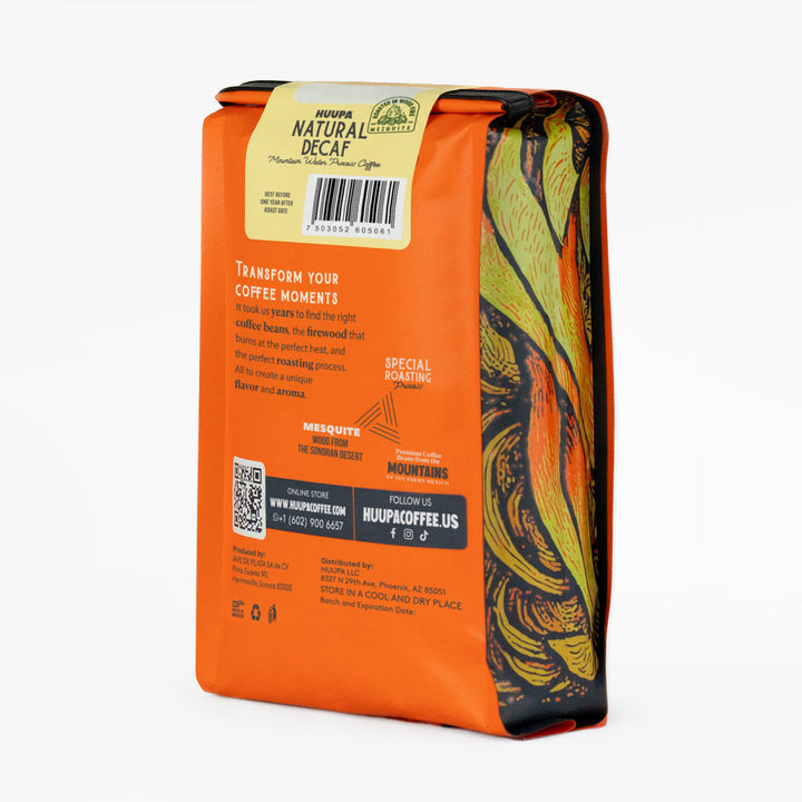Back of natural decaf coffee bag with decorative design and text on a white background