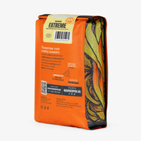 Orange Huupa Extreme Coffee bag with colorful design and text on a white background with the details in the back of the bag