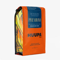 Orange coffee bag with 'HUUPA Premium Coffee' branding on a white background