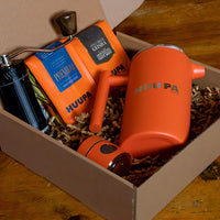 Orange Huupa products in a cardboard box on a wooden surface