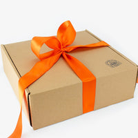 Brown gift box with an orange ribbon on a white background