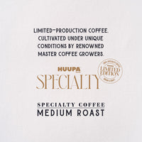 Promotional graphic for Huupa Coffee Specialty Coffee Medium Roast, featuring dark navy text and gold branding on a textured off-white background.