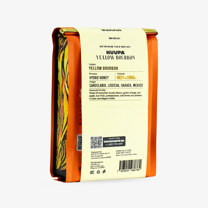 A package of Huupa Yellow Bourbon coffee shown from the back, featuring a cream-colored label with black text and a bright orange border, with a colorful yellow and orange patterned coffee bean illustration on the left side.
